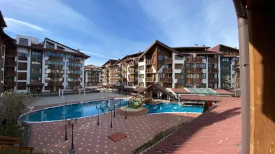 a large apartment complex with a swimming pool and buildings at Belvedere Holiday Club H70 in Bansko