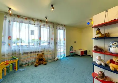 a childs room with stuffed animals in a room with a window at Belvedere Holiday Club H70 in Bansko