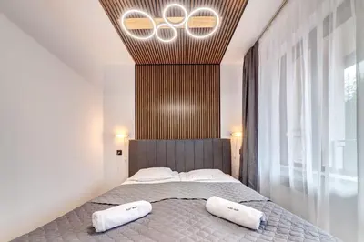 a bedroom with a bed with two pillows on it at Alpine Hideaway at The Castle in Smolyan
