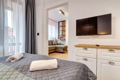 a bedroom with a bed and a flat screen tv at Alpine Hideaway at The Castle in Smolyan