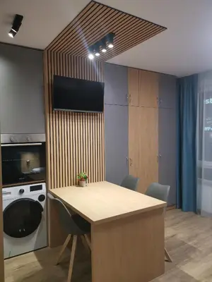 a kitchen with a table with chairs and a dishwasher at West Park in Sofia