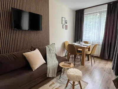 a living room with a couch and a table at RIA studio in Borovets Gardens hotel in Borovets