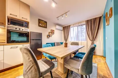 a kitchen and dining room with a wooden table and chairs at Ski-Friendly Family Getaway in Pamporovo