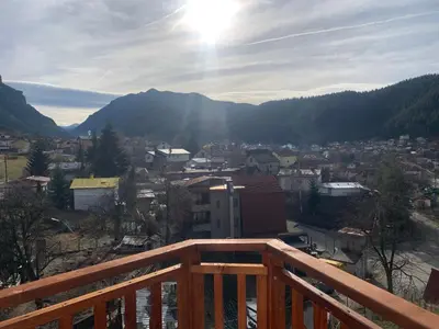 a view of a city from a wooden balcony at Rooftop apartment with stunning view in Beli Iskar