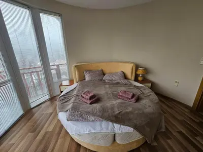 a bedroom with a large bed with two pillows on it at Rooftop apartment with stunning view in Beli Iskar