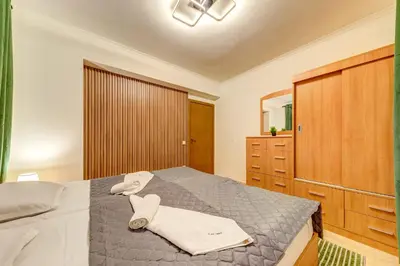 a bedroom with a bed with towels on it at Winter Heaven Grand Monastery Pamporovo in Pamporovo