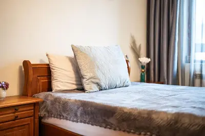 a bed with two pillows on it in a bedroom at 400m from Ski lift Belvedere Apartment - SPA - Free parking in Bansko