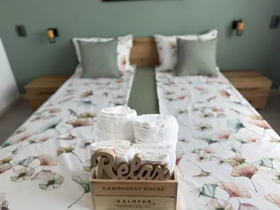 a bed with a box with towels on it at Къща Камберови град Калофер in Kalofer