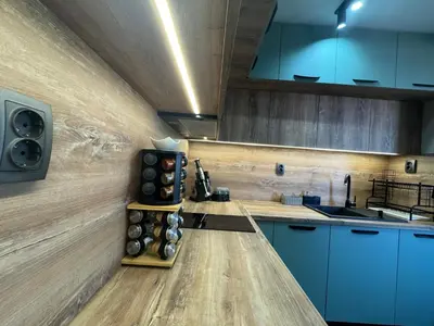 a kitchen with blue cabinets and a counter top at Къща Камберови град Калофер in Kalofer