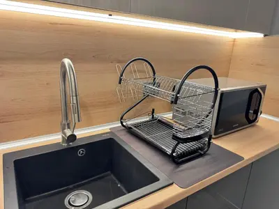a kitchen sink with a shopping basket on a counter at Plovdiv Moon - 1 Bedroom Luxury Apartment in Plovdiv