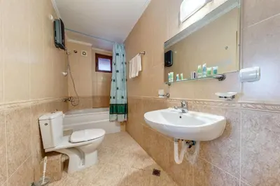 a bathroom with a toilet and a sink at Alpine Comfort at Grand Monastery in Pamporovo