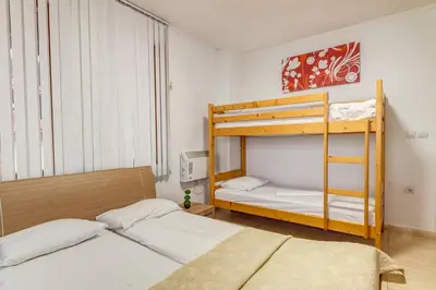 a bedroom with two bunk beds and a ladder at Alpine Comfort at Grand Monastery in Pamporovo
