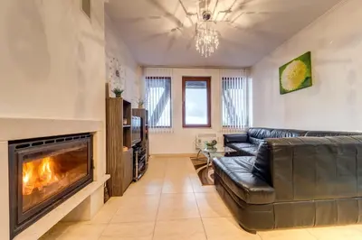 a living room with a couch and a fireplace at Alpine Comfort at Grand Monastery in Pamporovo