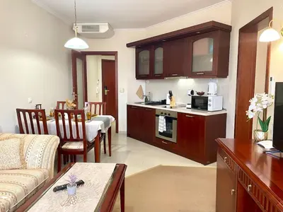 a kitchen and living room with a couch and a table at Cozy 1BR next to the Gondola by SI Stay in Bansko