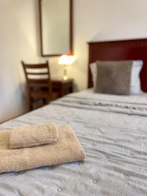 a pair of towels sitting on top of a bed at Cozy 1BR next to the Gondola by SI Stay in Bansko
