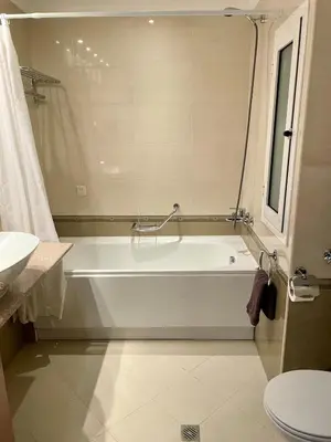a bathroom with a white tub and a sink at Cozy 1BR next to the Gondola by SI Stay in Bansko