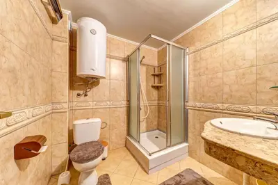 a bathroom with a shower and a toilet and a sink at Cozy Evrika 2 Mountain Home in Pamporovo