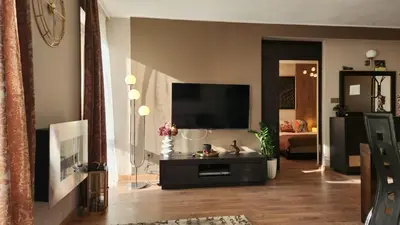 a living room with a flat screen tv at SPOMAR One Bedroom Apartment in Bansko