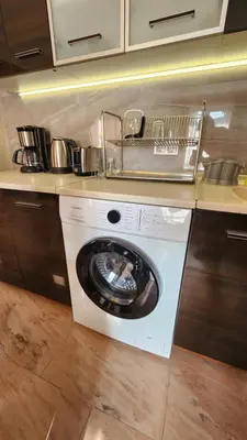 a kitchen with a washing machine in a kitchen at SPOMAR One Bedroom Apartment in Bansko