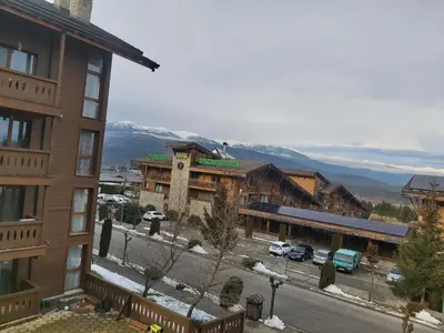 a view of a town with mountains in the background at Tranquility Apartment Pirin Golf in Razlog