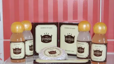a group of four bottles of cider with yellow caps at Villa Paris in Hisarya