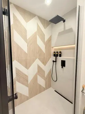 a bathroom with a geometric patterned wall at Lux Boutique 2 BDR apartment right next ski gondola lift in Bansko