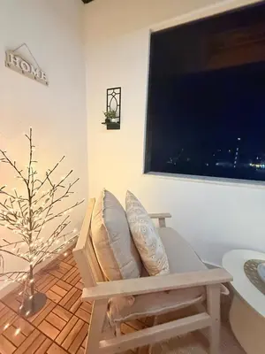 a living room with a chair and a large window at Lux Boutique 2 BDR apartment right next ski gondola lift in Bansko
