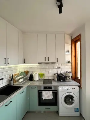 a kitchen with white cabinets and a washing machine at Cu29 Kapana art Apartments in Plovdiv