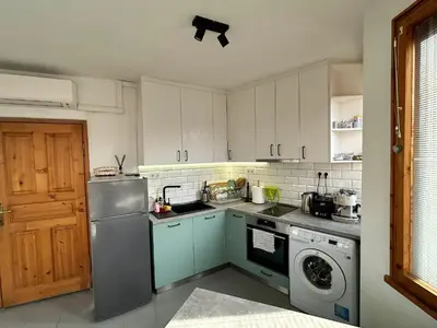 a kitchen with a refrigerator and a washing machine at Cu29 Kapana art Apartments in Plovdiv