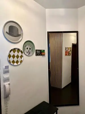 a hat on a wall next to a door at Kosara Apartment Home2Host in Bansko