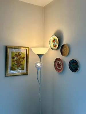 a corner of a room with a lamp and some plates at Kosara Apartment Home2Host in Bansko
