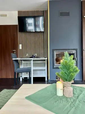 a living room with a table and a christmas tree at Kosara Apartment Home2Host in Bansko