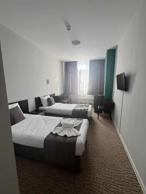 a hotel room with two beds and a television at Мотел КОМПЛЕКС GRILL and CHILL in Levunovo