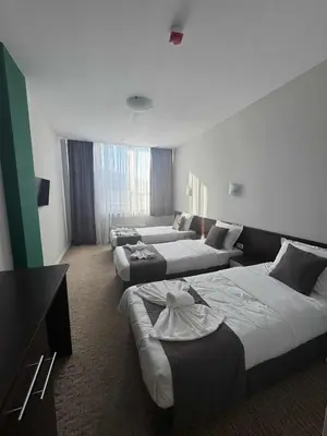 a hotel room with three beds and a couch at Мотел КОМПЛЕКС GRILL and CHILL in Levunovo