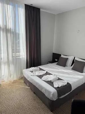 a bedroom with a large bed with towels on it at Мотел КОМПЛЕКС GRILL and CHILL in Levunovo