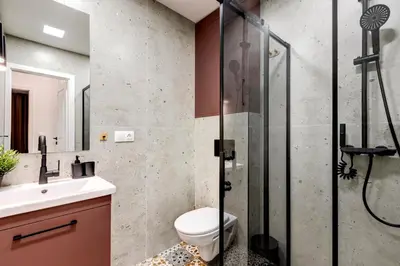 a bathroom with a shower and a toilet and a sink at Newly Renovated Comfortable First-Floor Stay in Sofia