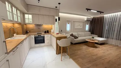 a kitchen and a living room with a couch at Lux Living Apartments in Plovdiv