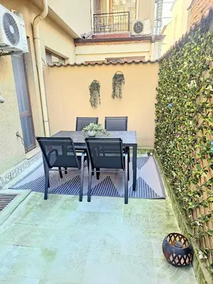 a black table and chairs sitting on a patio at Kapana Garden - 4 persons luxury apartment in Plovdiv