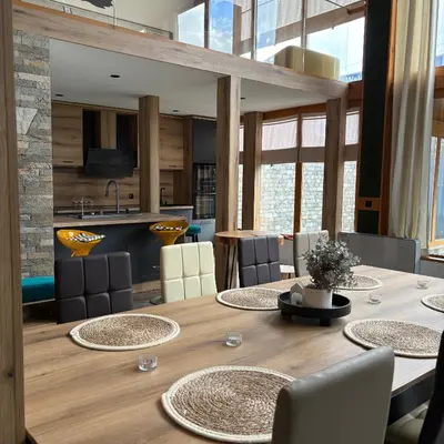 a dining room with a large wooden table and chairs at Loft Chalet Bansko in Bansko
