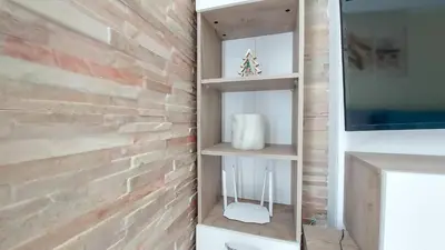 a bathroom with a brick wall and shelves at Аpartment C103 Grand Bansko 1 in Bansko