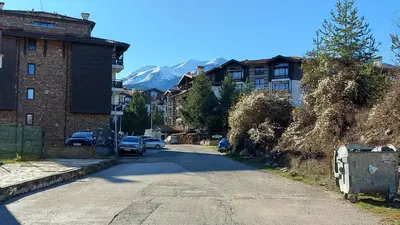 an empty street with buildings and a mountain at Аpartment C103 Grand Bansko 1 in Bansko