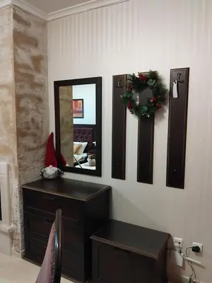 a room with a dresser and a mirror on a wall at Ski point in Pamporovo