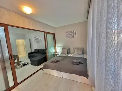 a bedroom with a bed and a large mirror at 2BR Snowflake Stay Bansko by SI Stay in Bansko