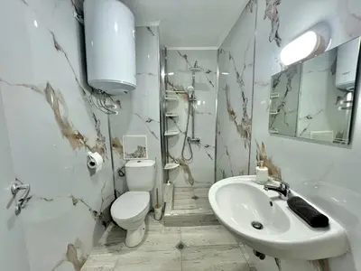 a white bathroom with a toilet and a sink at 2BR Snowflake Stay Bansko by SI Stay in Bansko