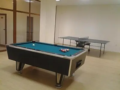 a pool table in a room with two tables at 2BR Snowflake Stay Bansko by SI Stay in Bansko