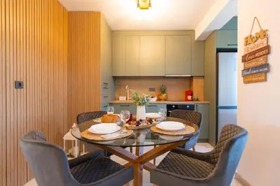 a kitchen and dining room with a table and chairs at Domus Apartments Vista in Plovdiv