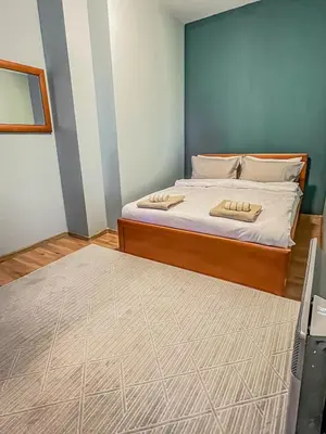 a bedroom with a bed with two towels on it at Fireplace Apartment near Bus & Train Station in Bansko