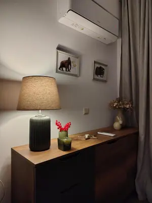 a desk with a lamp on top of it at Family Apartment Royal Tower in Bansko