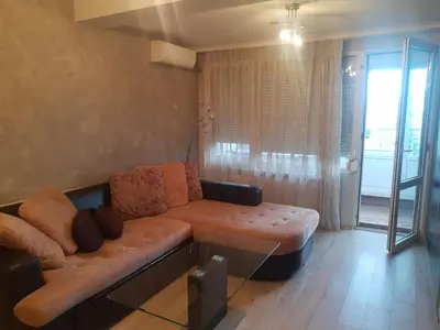 a living room with a couch and a table at Apartment near Bulgaria Boulevard in Sofia