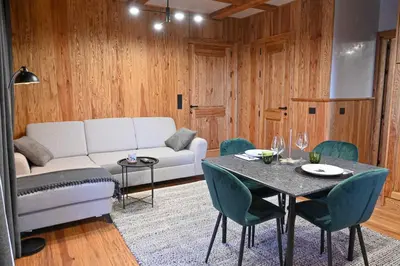 a living room with a couch and a table with chairs at Cozy 1-Bedroom Apartment in St Ivan Ski Resort by Flat Mаnаger in Blagoevgrad
